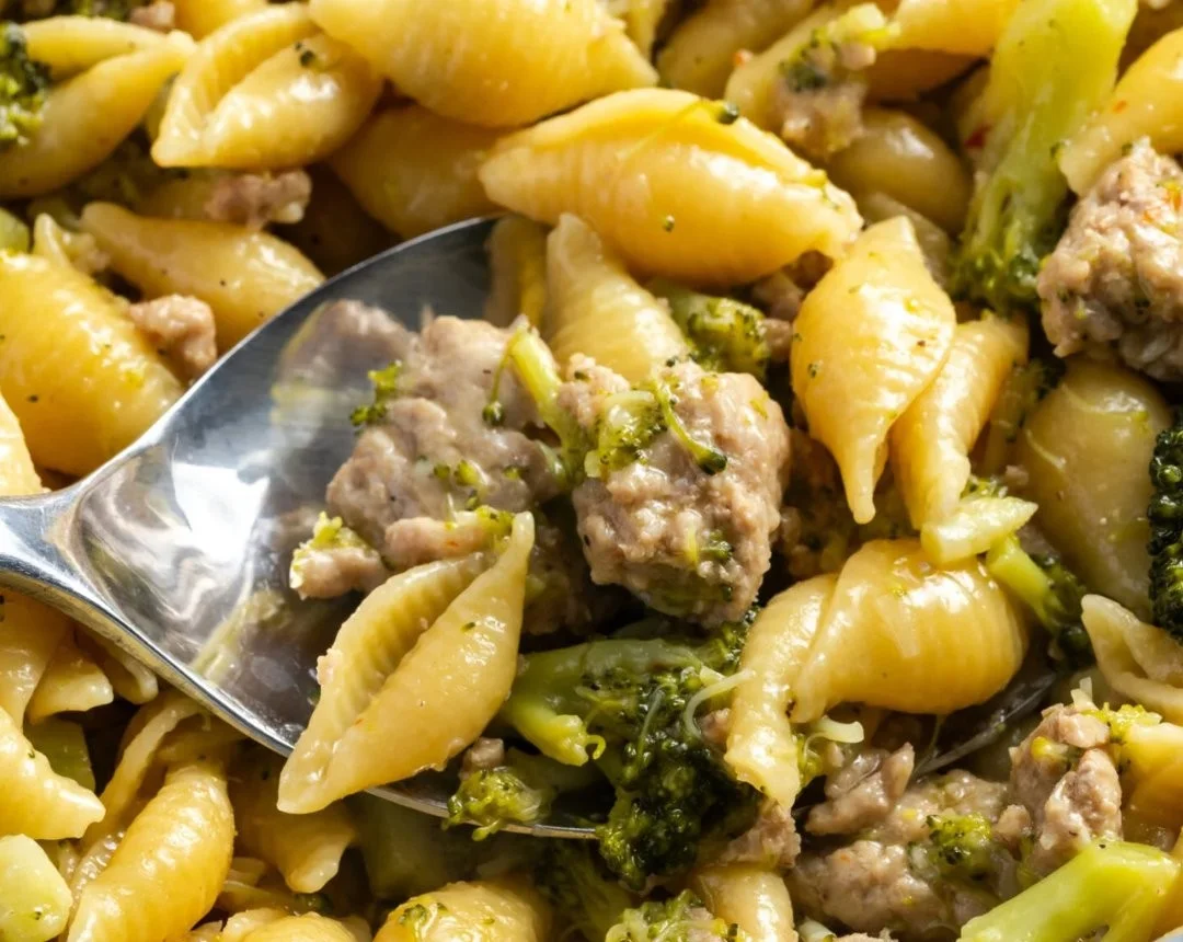 Bowl of broccoli ground turkey pasta with fresh herbs and cheese
