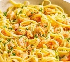 Delicious garlic butter shrimp pasta served in a bowl with herbs and garnishes