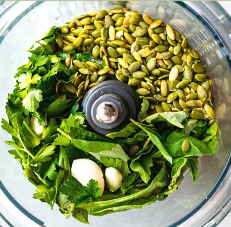 Nut-free pumpkin seed pesto in a bowl with fresh herbs
