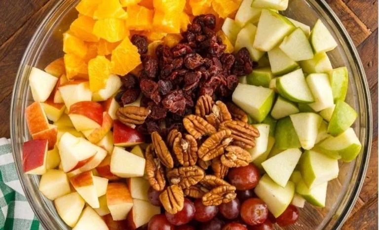 Apple fruit salad served with a fall-spiced dressing for a tasty autumn treat.