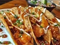 Delicious Chicken Wonton Tacos served with sauces and toppings