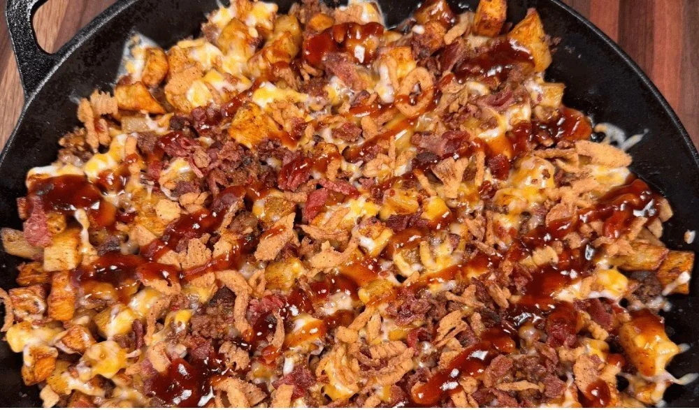 BBQ cheeseburger potato skillet garnished with toppings