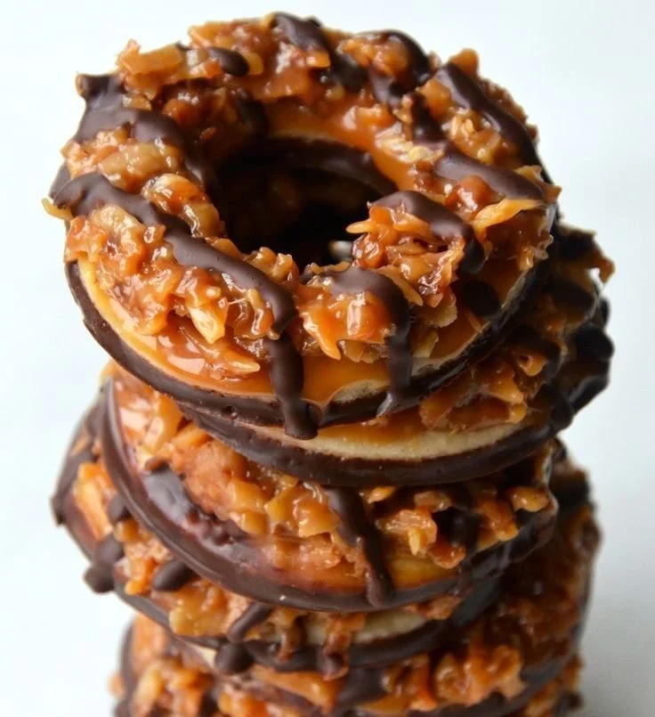 Homemade Samoas cookies with chocolate, caramel, and coconut on a plate