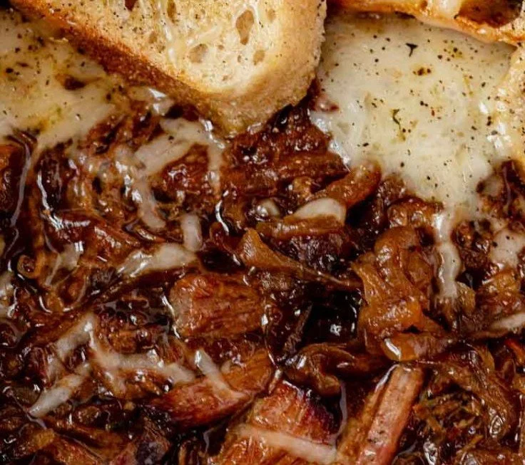 Delicious French onion pot roast with onions and herbs in a rustic dish