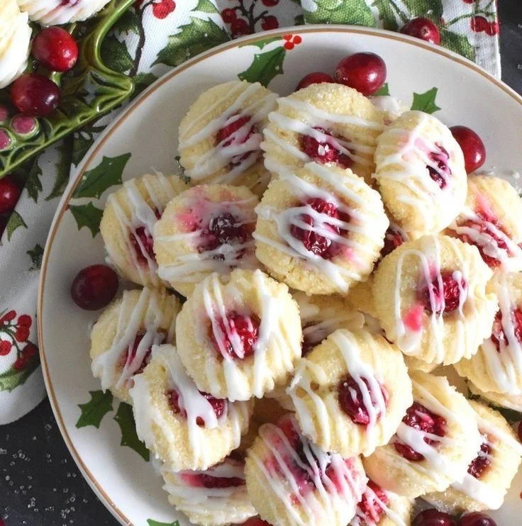 Baked lemon cranberry cookies on a cooling rack with a hint of lemon zest