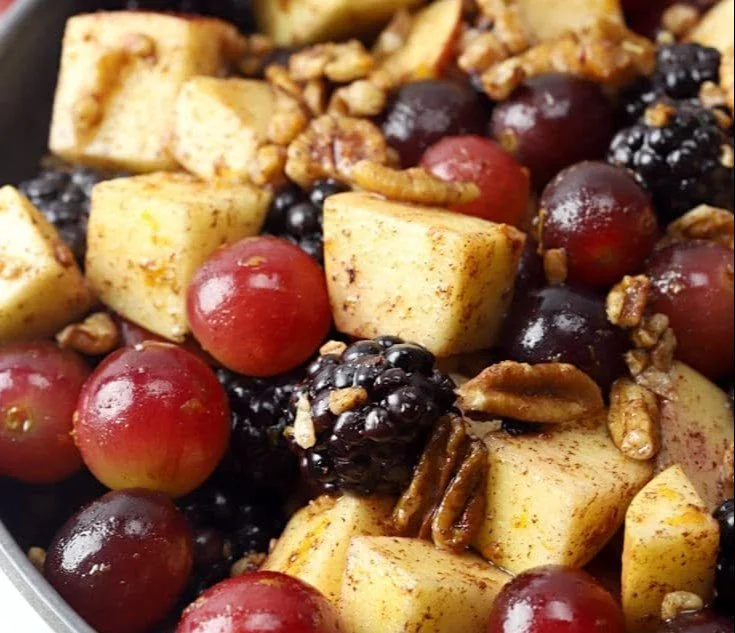 Fall fruit salad with cinnamon orange dressing, featuring assorted fresh fruits.