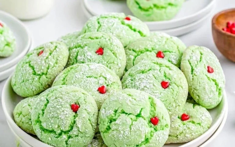 Festive Grinch Cookies decorated for Christmas with green icing and red accents.