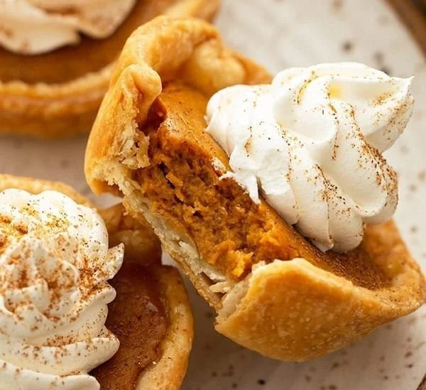 Delicious mini pumpkin pies served on a festive table.