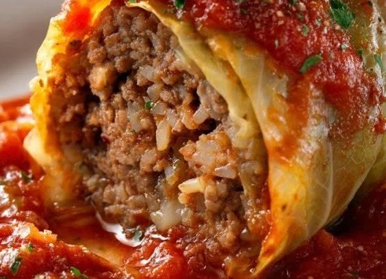 Homemade stuffed cabbage rolls ready to serve on a plate.