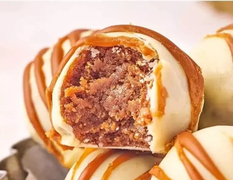No-bake Biscoff truffles coated in chocolate and decorated with crumbled cookies