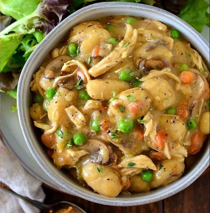 One-Pot Chicken Pot Pie Gnocchi served in a bowl with fresh herbs