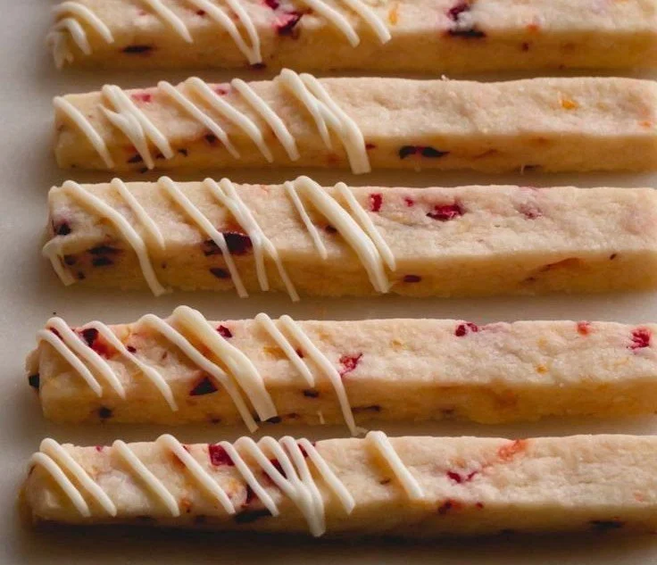 Freshly baked orange cranberry shortbread cookies on a plate