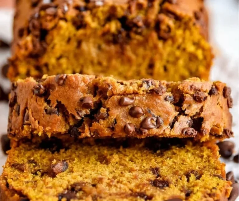 Sliced pumpkin bread with chocolate chips on a wooden table