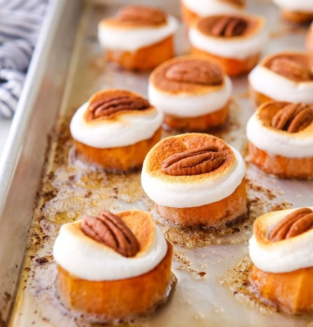 Sweet potato bites topped with marshmallows and pecans for a delicious snack